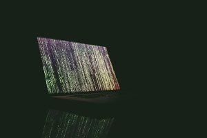 laptop in the dark with code